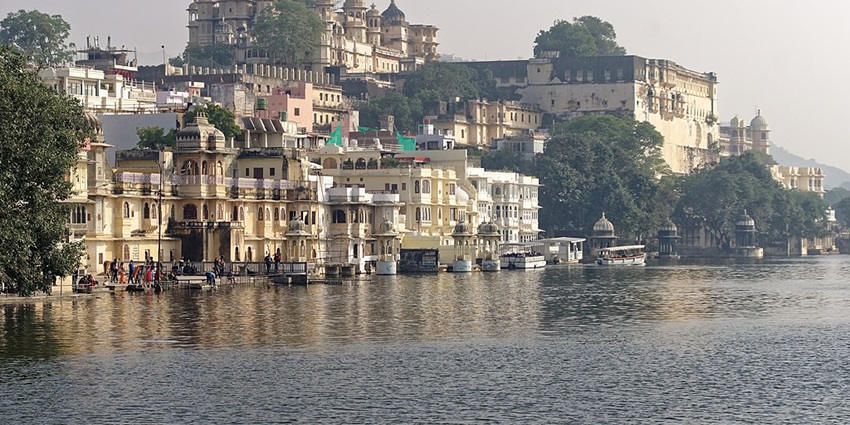 A serene view of Lake Pichola in Udaipur, with calm water reflecting relaxing vibes.