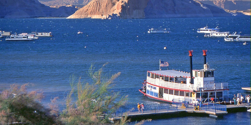 An image of Red rock canyons surrounding the clear waters of Lake Powell.