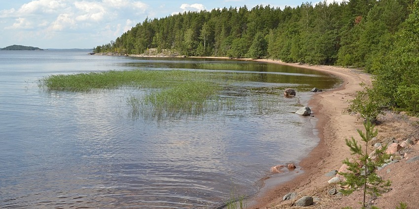 An image of Lake Saimaa, Finland, capturing a stunning sunset over its tranquil waters.