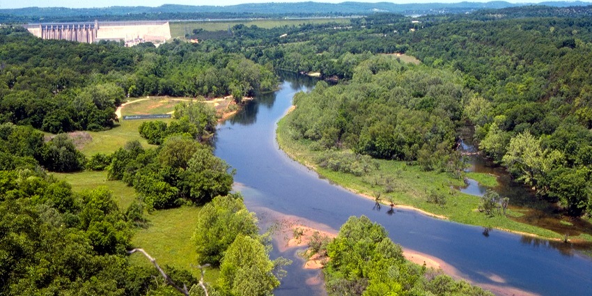 An image of Lake Taneycomo in Missouri from above with the table rock dam in the back