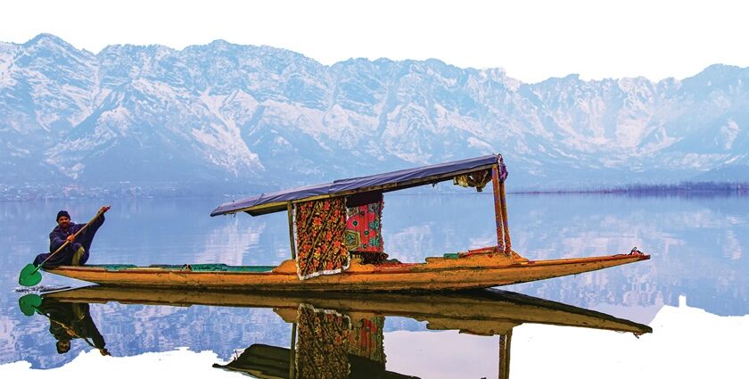 Dal Lake in Srinagar with shikaras, houseboats, and a picturesque mountain backdrop.