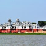 Lake in Tripura with a bright red and white neer mahal with its unique architecture