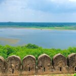 A picturesque view of a wide and shallow Mansarovar Lake as seen from a nearby fort.