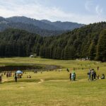 Khajjar with houses and structures and mountains covered with green trees in the background Viewers of this file can see comments and suggestions