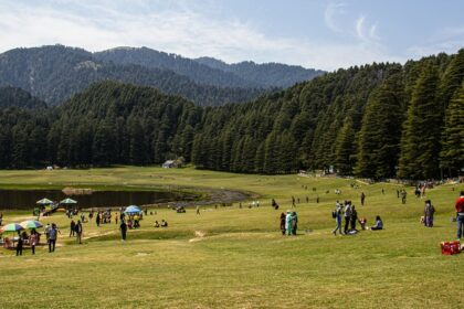 Khajjar with houses and structures and mountains covered with green trees in the background Viewers of this file can see comments and suggestions