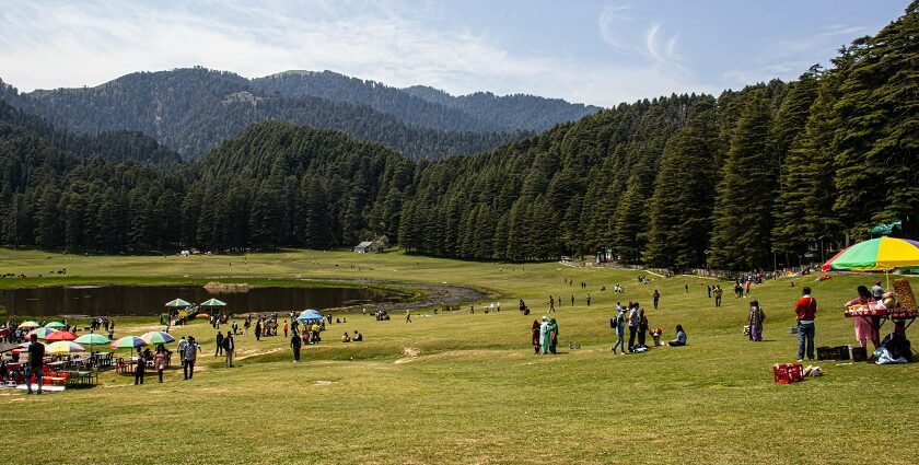 Khajjar with houses and structures and mountains covered with green trees in the background Viewers of this file can see comments and suggestions