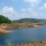 A picture of the largest artificial lake in India, showing the vast landscape and surrounding hills.