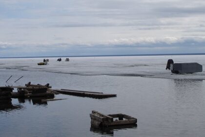 The largest lake in Canada with ruined wood and broken pieces lying on the shore.