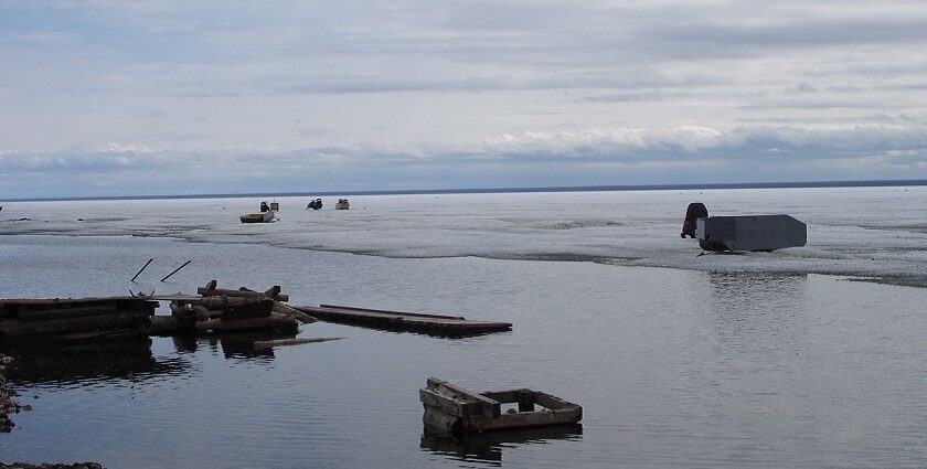 The largest lake in Canada with ruined wood and broken pieces lying on the shore.