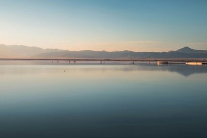 Bright sunset at the Sambhar Lake with the sun reflecting on the large saltwater body