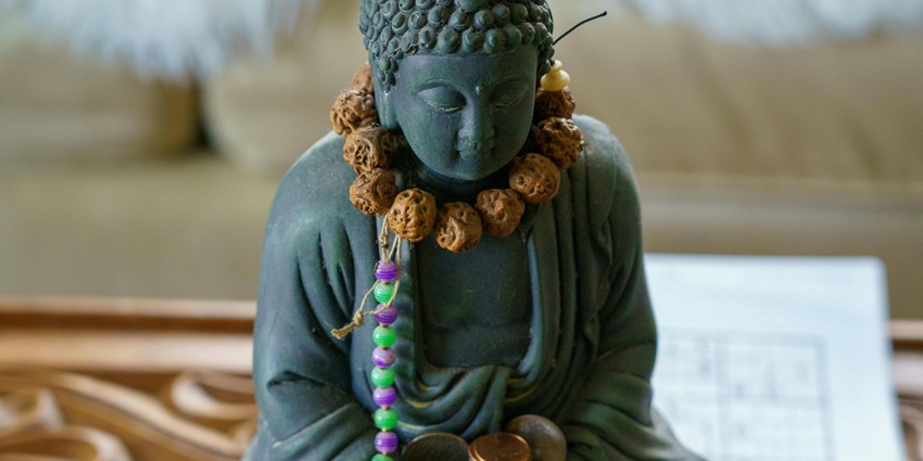 Image of Statue of Buddha with Garland and Beads