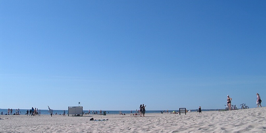 Wide sandy beach with strong waves, famous for its music festivals and vibrant summer atmosphere.