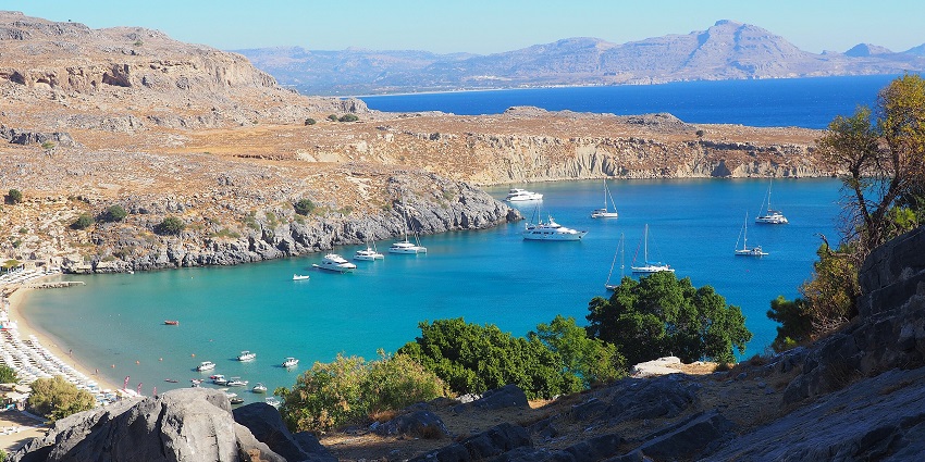 Picturesque view of Lindos-akropol around rocky hills during day time