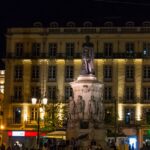 Image of aesthetic view of Lisbon’s nightlife - people strolling around at night