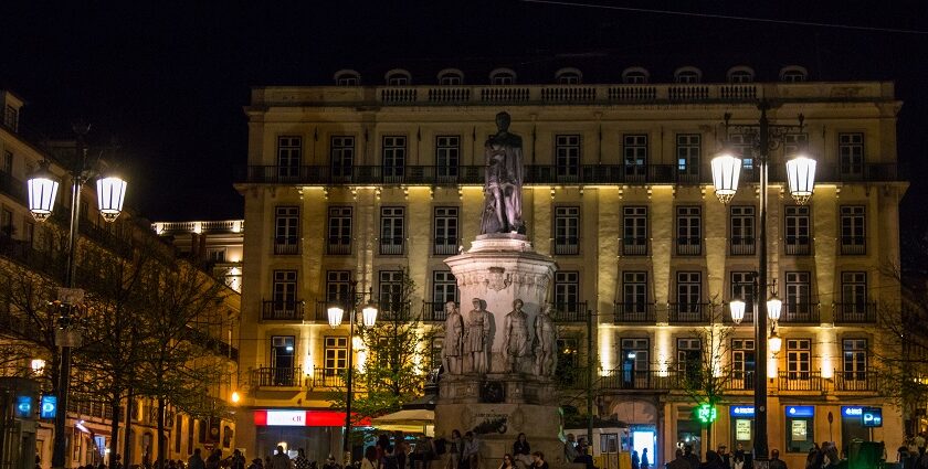 Image of aesthetic view of Lisbon’s nightlife - people strolling around at night