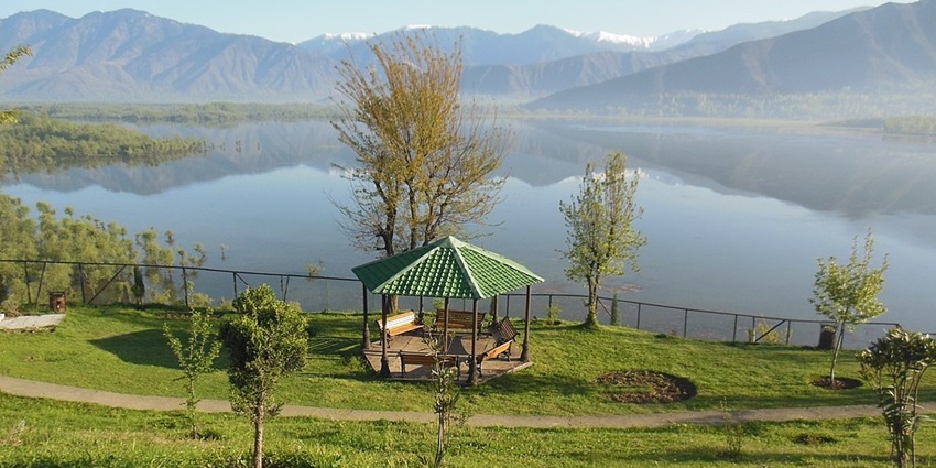 Beautiful Wular Lake is full of lotus and surrounded by mountains and lush greenery.