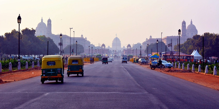 The picture of the yellow bus one the road during the daytime in New Delhi, India.