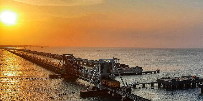 A magnificent view of sunset at Pamban Bridge, connecting Rameswaram, as mentioned in the Tamil Nadu travel guide.