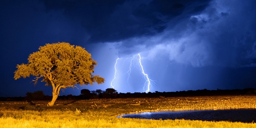 The dark blue sky is looking mesmerising as it is lightening at waterhole in Etosha