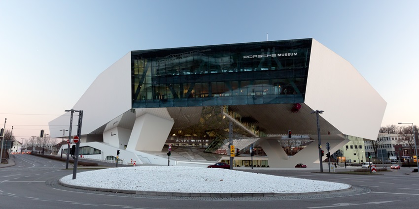 An image showing the exterior of the Porsche Museum, showcasing its modern architectural style