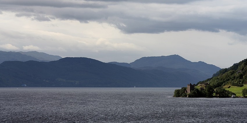 An image of Loch Ness, Scotland, featuring the historic Urquhart Castle along its deep waters.