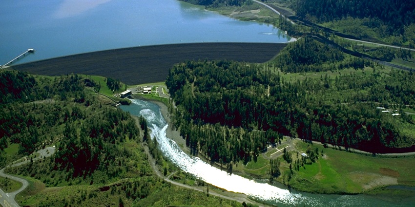 An aerial view of USACE William L Jess Dam releasing water from Lost Creek Lake.