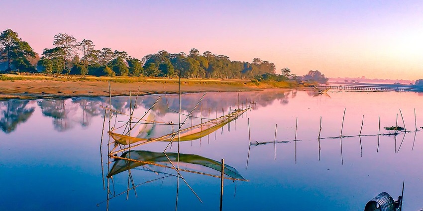 An image showing Majuli, the world's largest river island, surrounded by the peaceful Brahmaputra River.