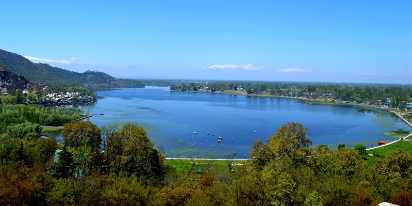 An image of one of the lakes in Jammu and Kashmir with tranquil waters and lush greenery.