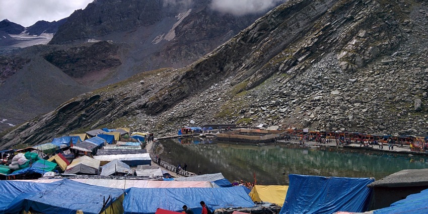 Manimahesh Lake with several camps, tents laid out and devotees standing in the distance