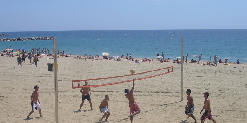 Image of people playing beach volleyball - Perfect escape at Mar Bella Beach