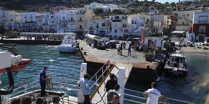 Visitors near the port and boats - admire the beauty that Marina Grande is