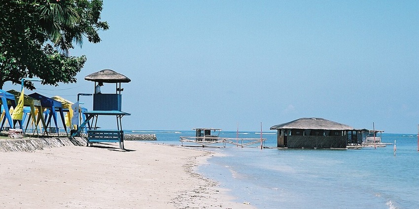 Matabungkay Beach, a family-friendly beach with calm waters and floating bamboo cottages.