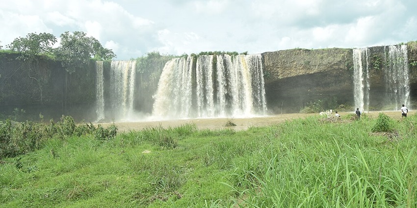 Charming Nigerian waterfall nestled in rocky landscapes, offering a serene and refreshing natural retreat.