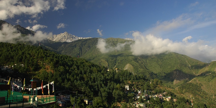 An image of a view over McLeod Ganj, a hill station in Himachal Pradesh, surrounded by the Himalayas