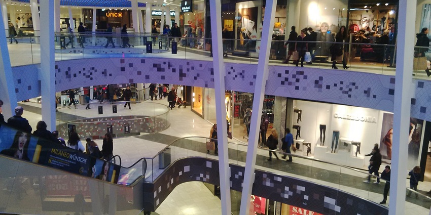 The interior of Milaneo Stuttgart, a modern shopping mall with many shops and restaurants.
