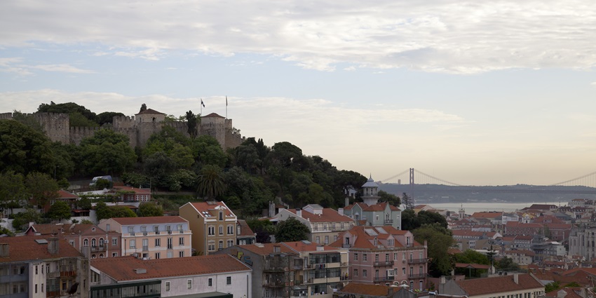 Beautiful houses and a bridge are seen from Miradouro da Graça or Graça Viewpoint in Lisbon.