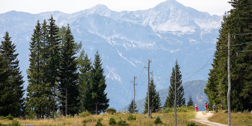 Travelers enjoying mountain biking at the Triglav National Park amidst beautiful scenery
