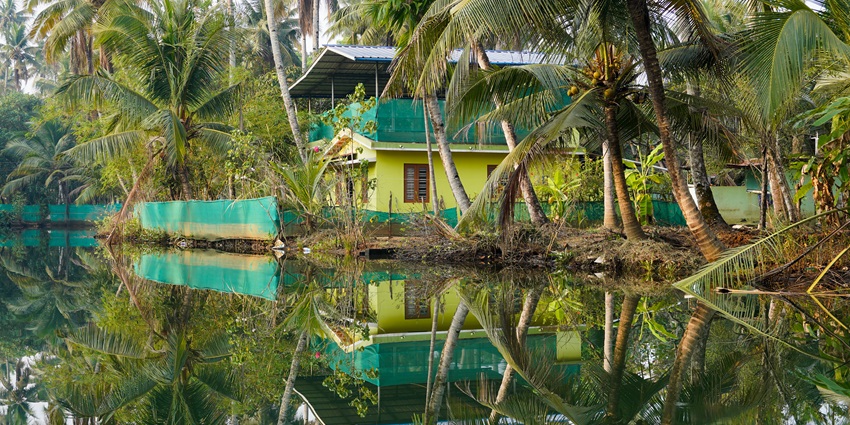 A picture of a house on Munroe Island, with its reflection falling on the nearby waters