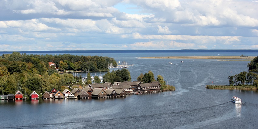 Müritz Lake in Germany a scenic gem with charming lakeside houses, boats, and greenery