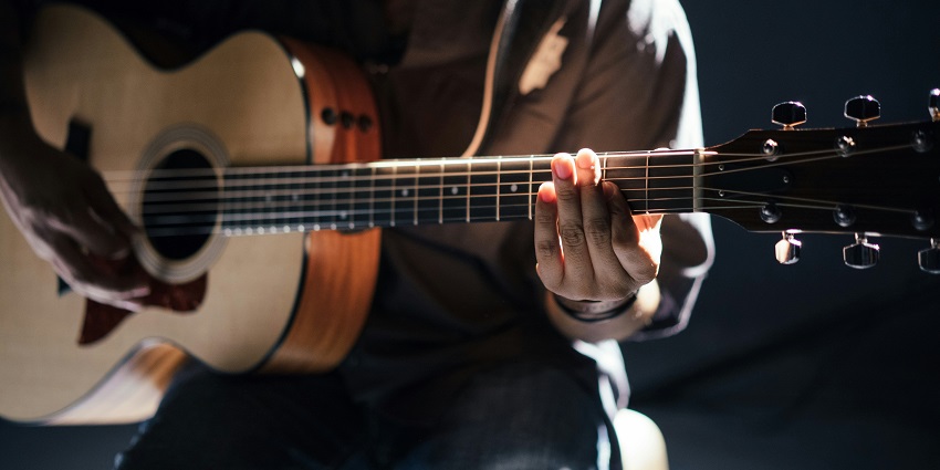 Image of a man playing guitar for visitors - A place that caters to every taste of Music