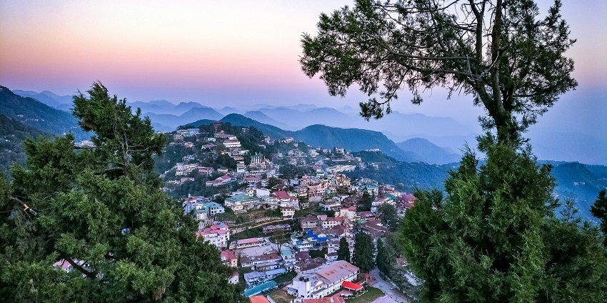 Panoramic view of Mussoorie Hill Station, with misty mountains and lush green landscapes