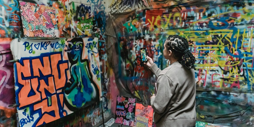 A woman admiring the live art and graffiti made for the Carnival in Goa.