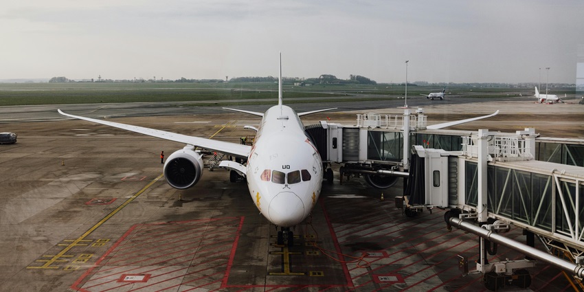 Aerial snap of an aeroplane standing connected with the bridge for onboarding