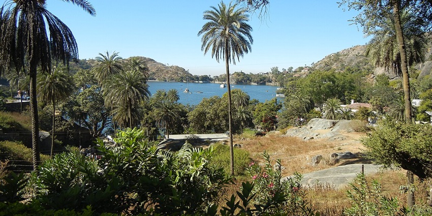 An image of Nakki Lake in Mount Abu with serene waters, greenery, and a scenic backdrop