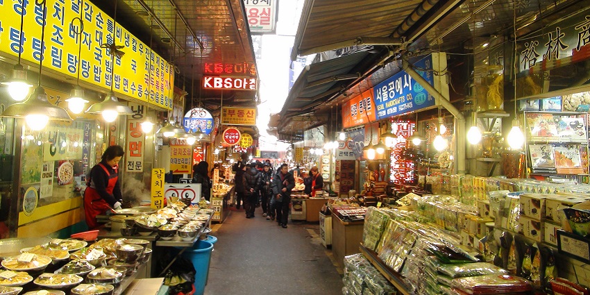 An image of Namdaemun Market, a large traditional market offering street food, souvenirs.