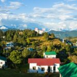 An image of a group of houses in a valley and mountain viewpoints in Chaukori, Uttarakhand.