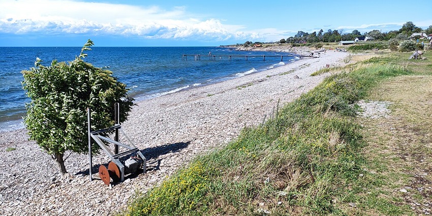 An image showing Djupvik beach on Öland, featuring serene waters and sandy shores