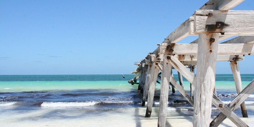 Rustic wooden jetty at Old Bight Beach, Cat Island, a hidden gem among Bahamas beaches