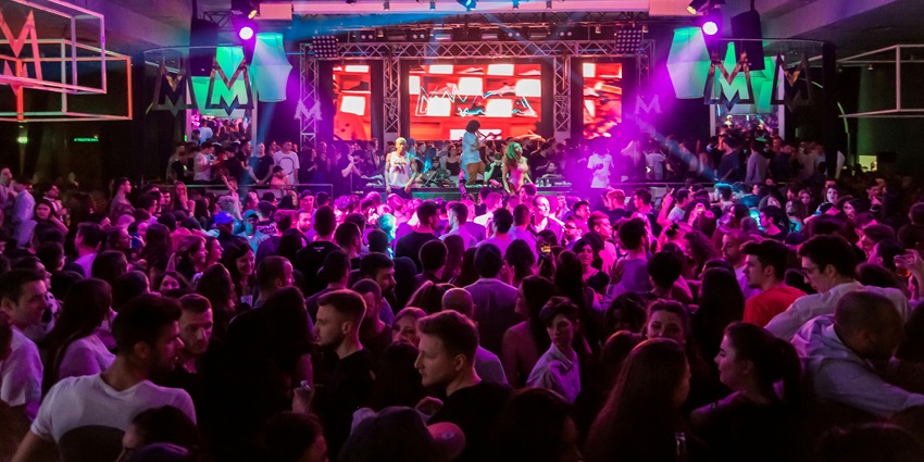 An image of crowd enjoying the DJ, resembling the nightlife experience in Olivia Valere
