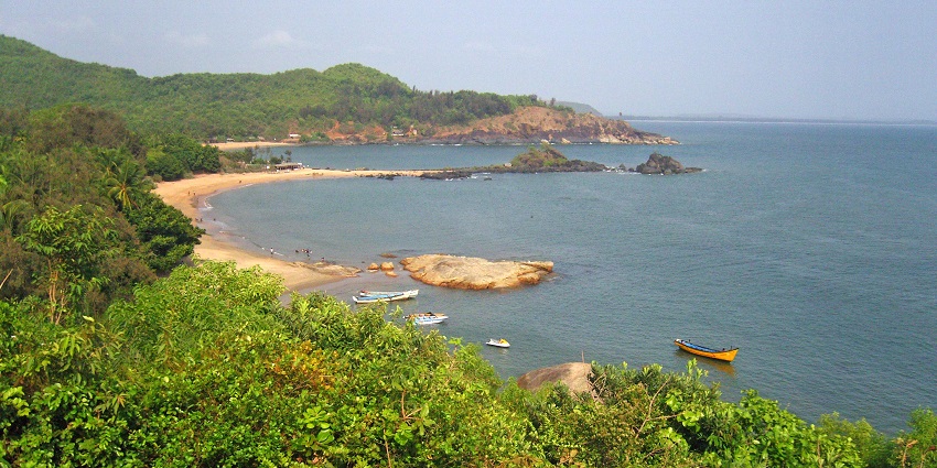 An image of the Om Beach, one of the famous bikini beaches in India, under a clear sky.